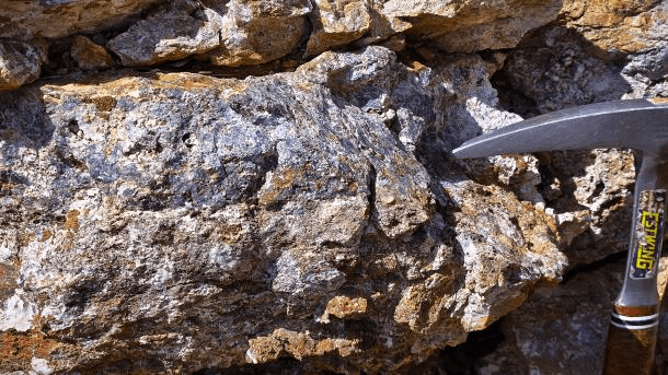 Ore sample with field hammer from the district